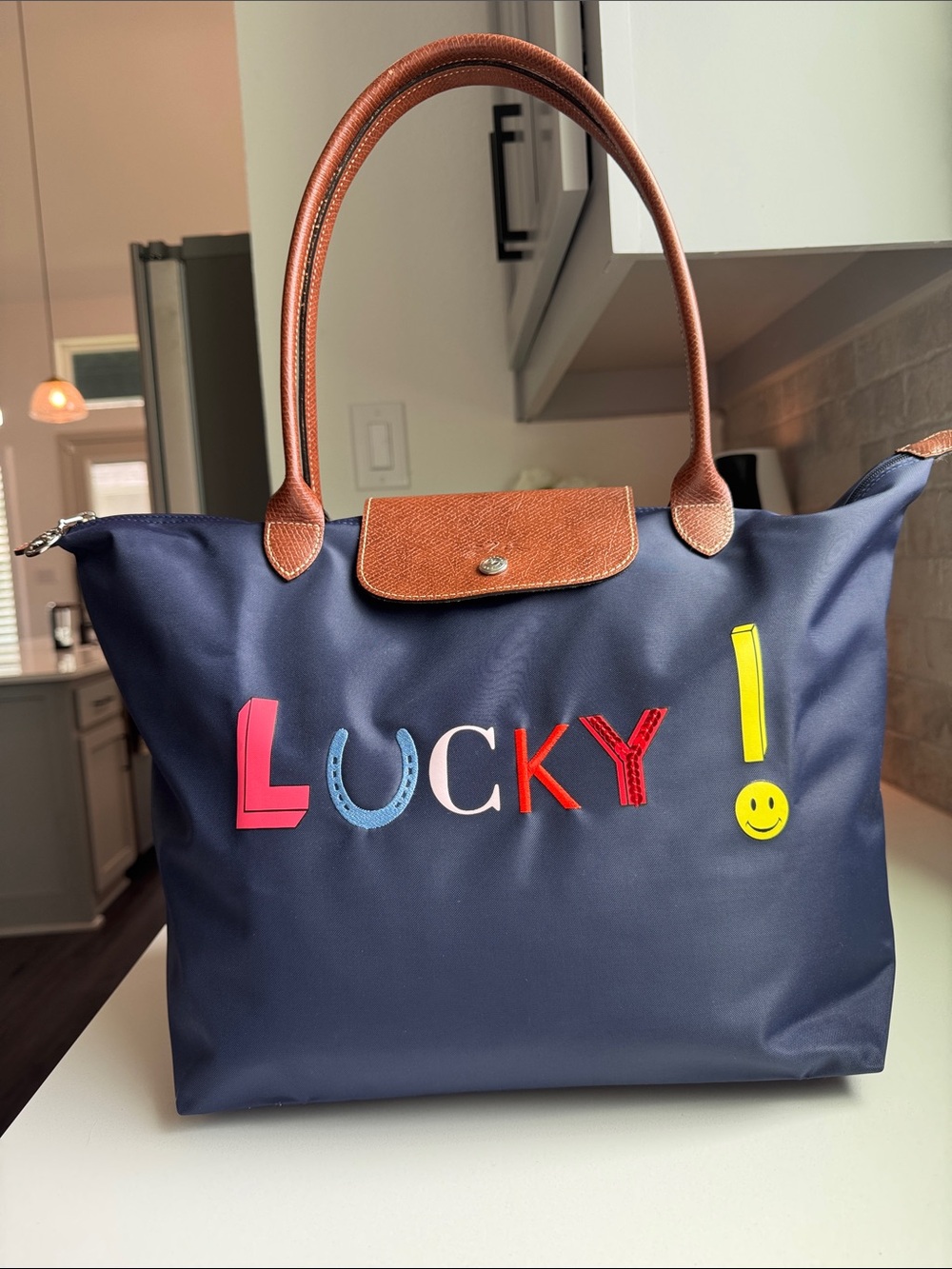 Longchamp Navy Le Pliage Tote with Multicolor 'Lucky' Appliqué.